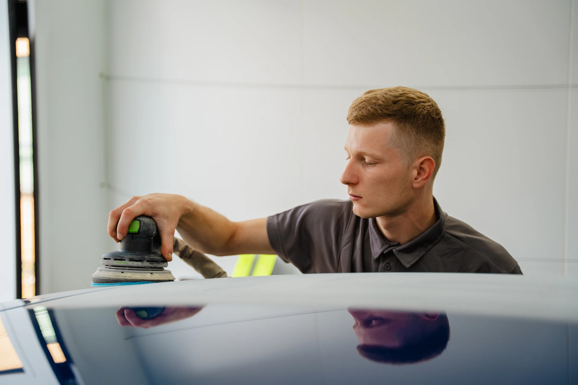 AutoLux employee polishing paintwork